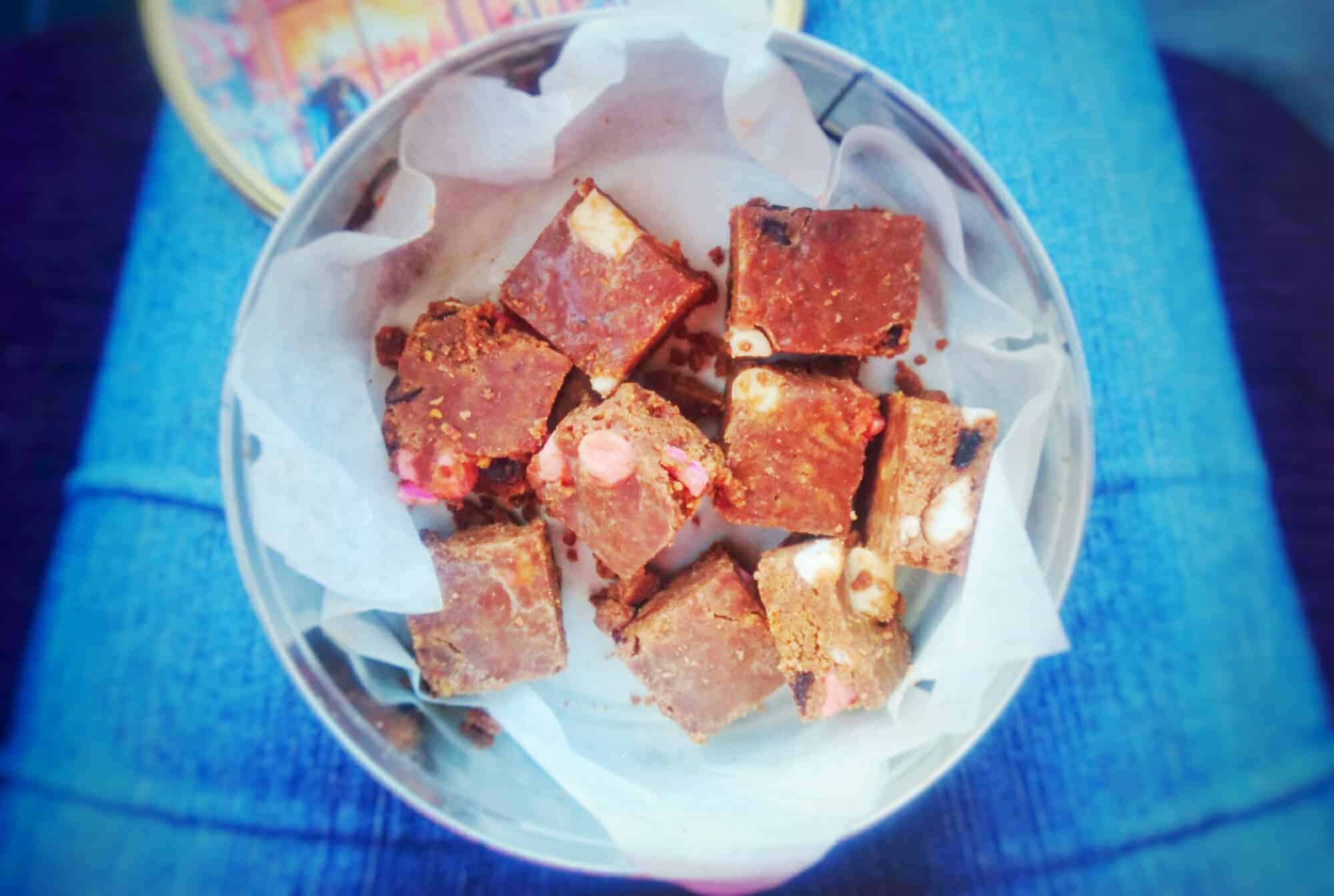 Chocolate tiffin box tin on someone's lap