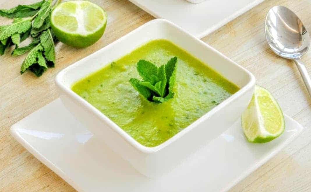 Slimming World Syn Free Pea & Mint Soup in white square bowl with mint and lime
