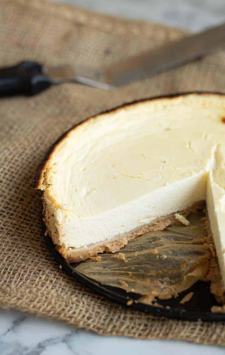 A close up of slice cut and removed from a homemade healthy quark cheesecake