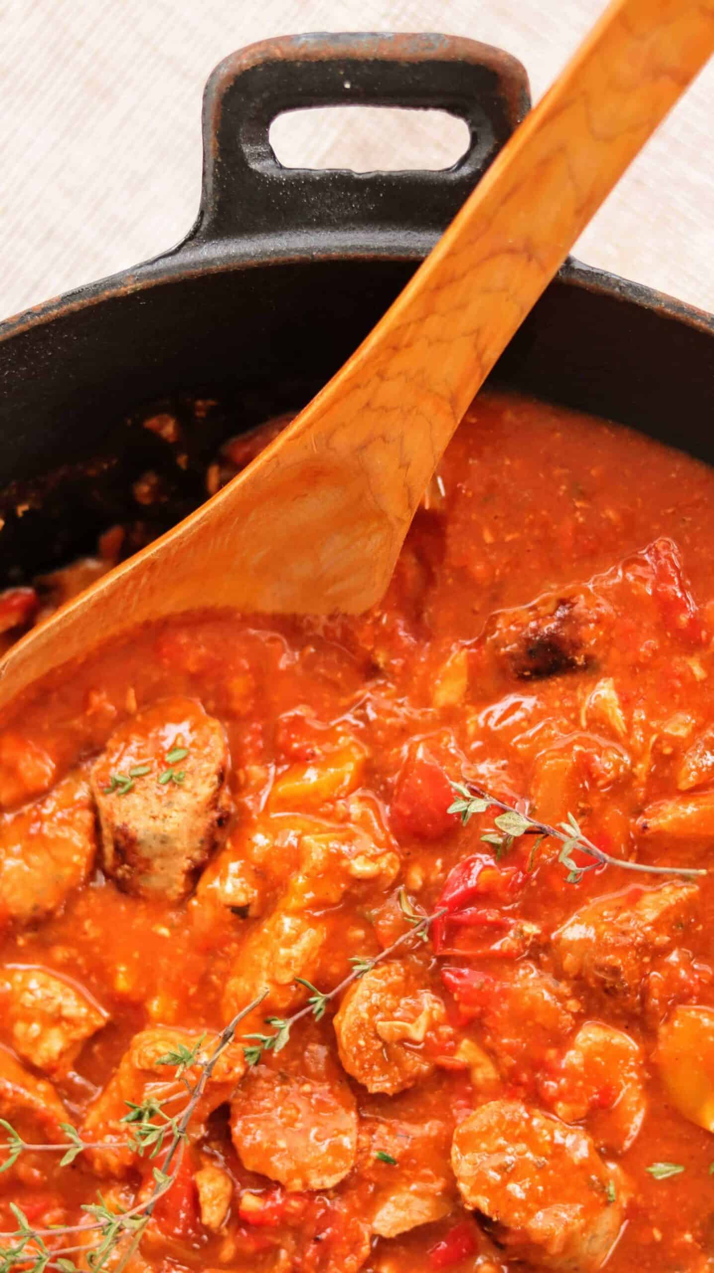 close up of a tomato based gumbo with fresh thyme