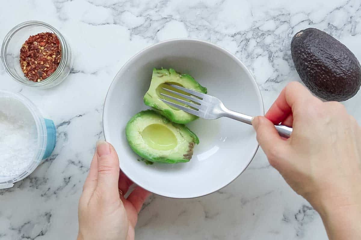 mashing up avocado with a fork
