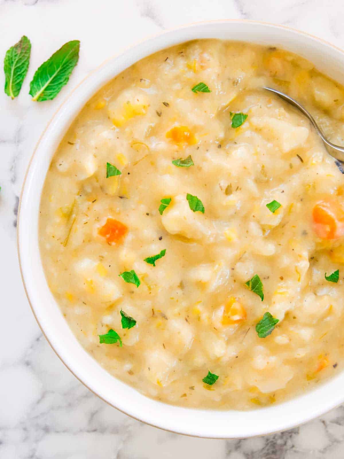 creamy cheesy potato soup in a Denby white Natural Canvas bowl