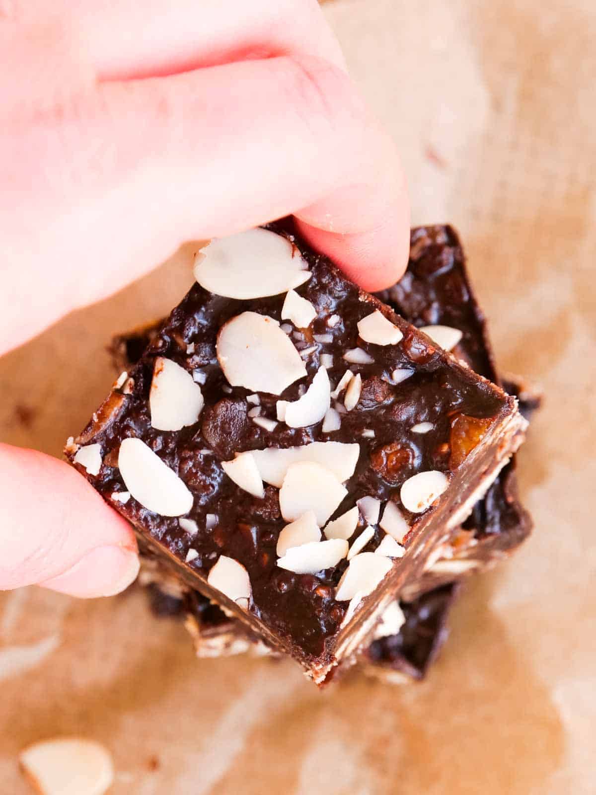 grabbing a chocolate square with almonds, biscuits and sweet liqueur