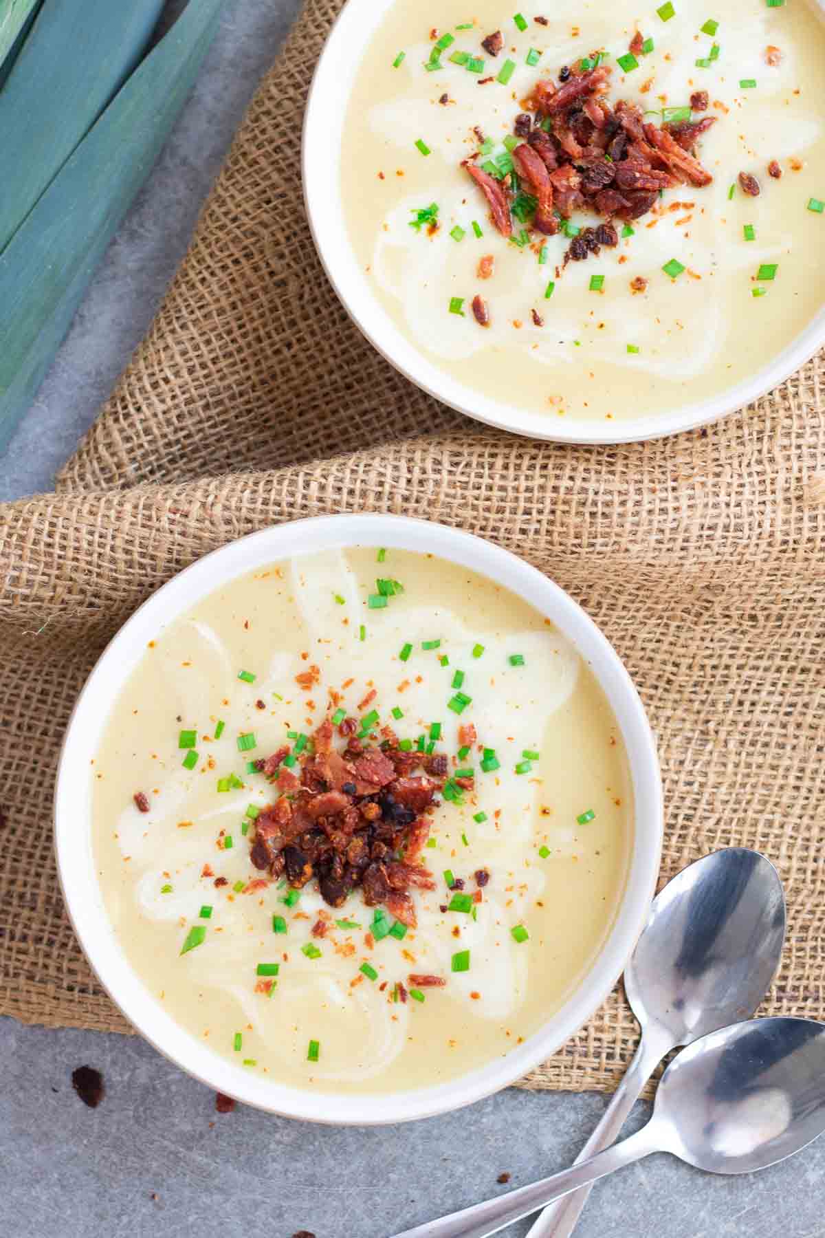 grilled bacon on potato and leek soup with 2 spoons