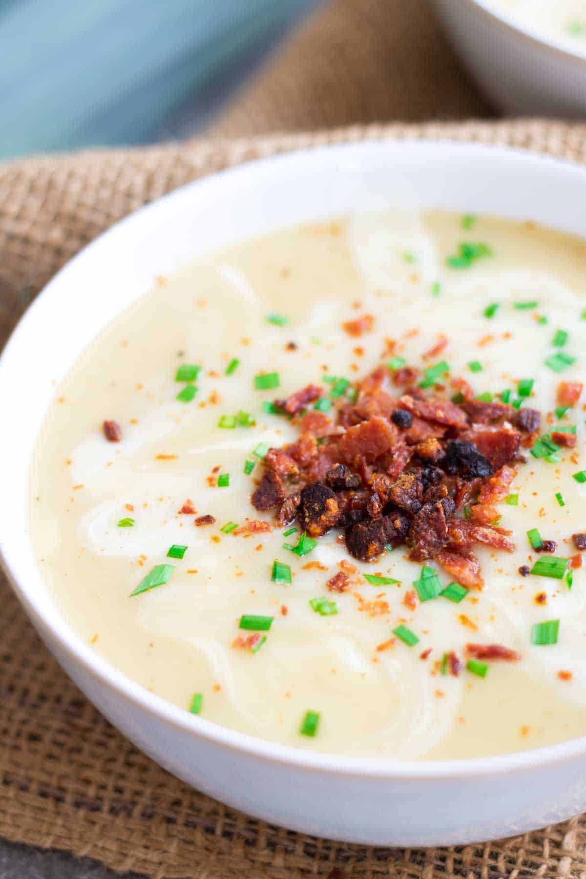 close up of leeky potato soup with chives and bacon