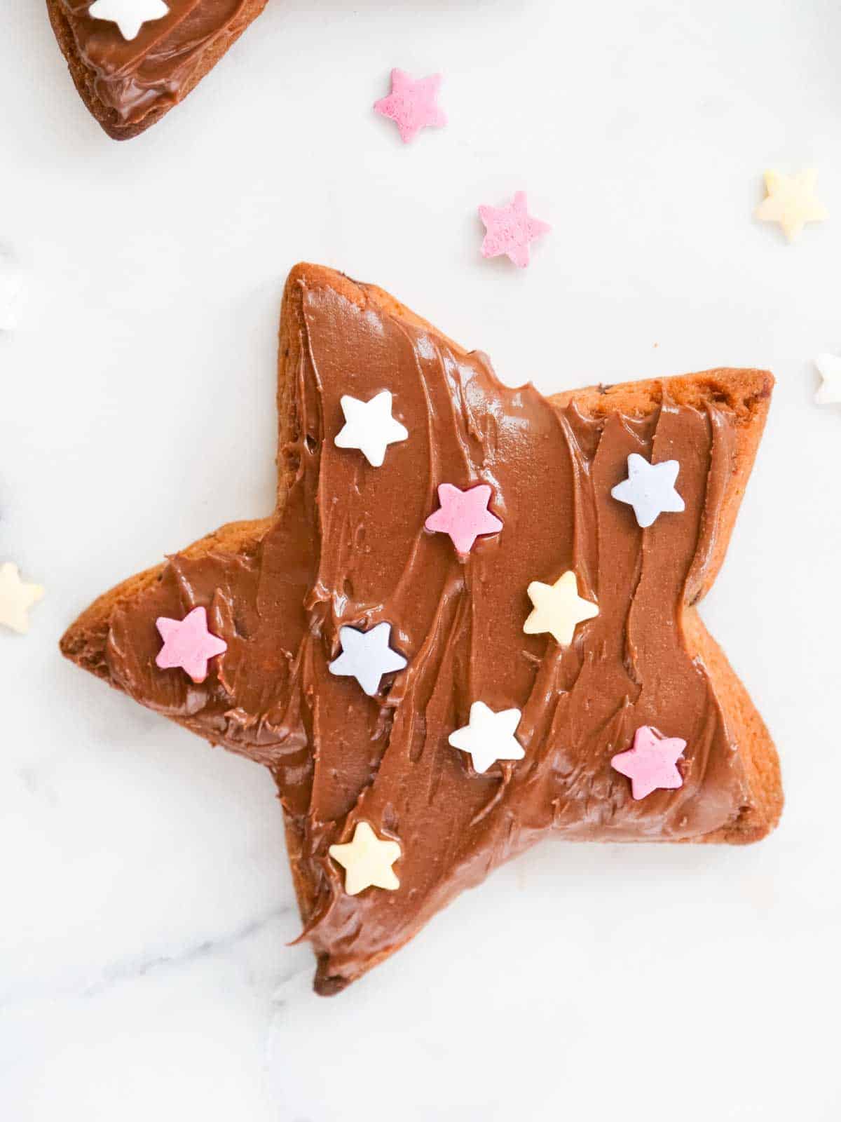 close up of Nutella on a chocolate shortbread biscuit with Dr Oetker star icing sugar sprinkles