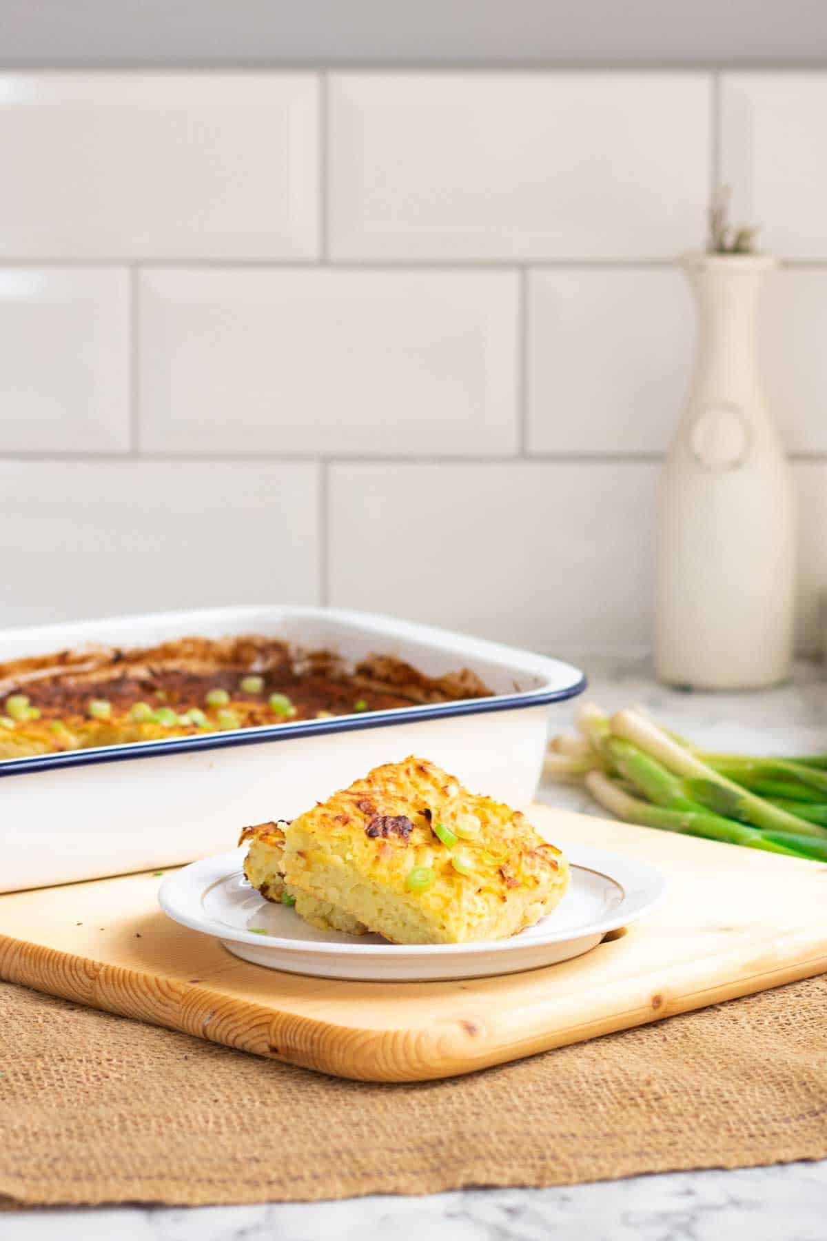 Savory kugel traybake made of grated potatoes, onions, cheese, eggs and natural yoghurt