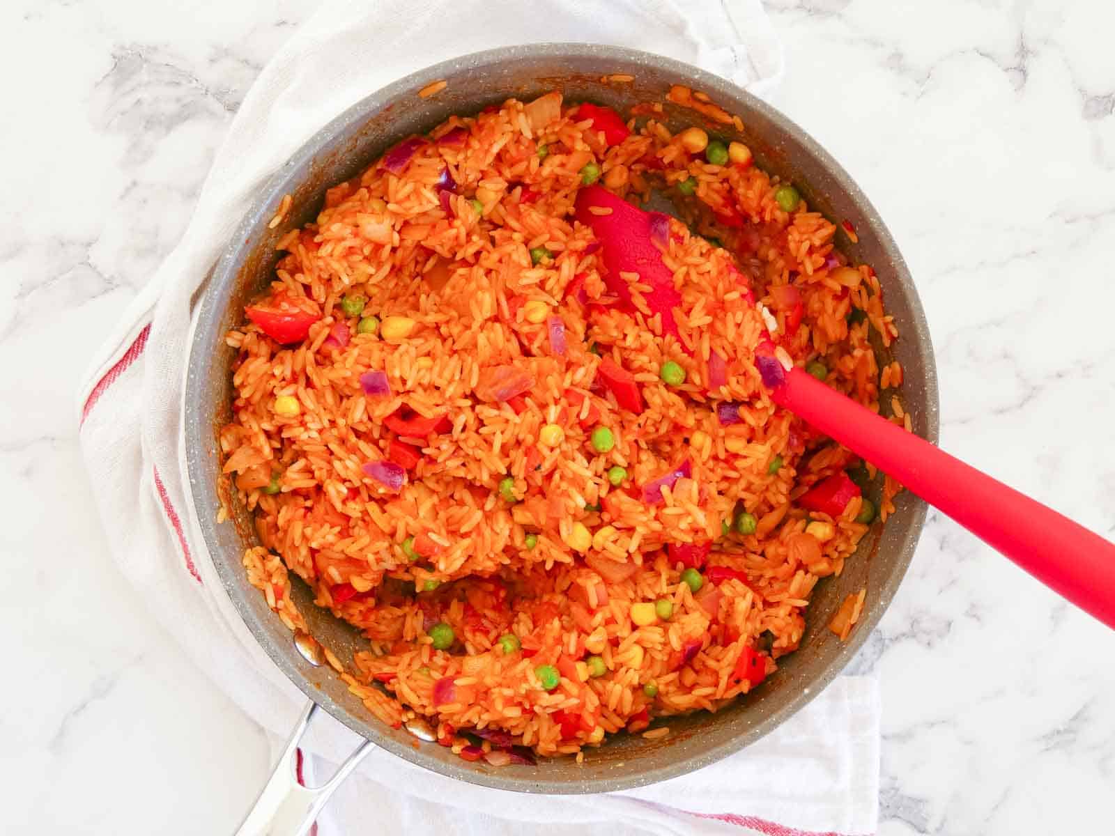 Easy Mexican rice all mixed together in a large frying pan, ready to serve
