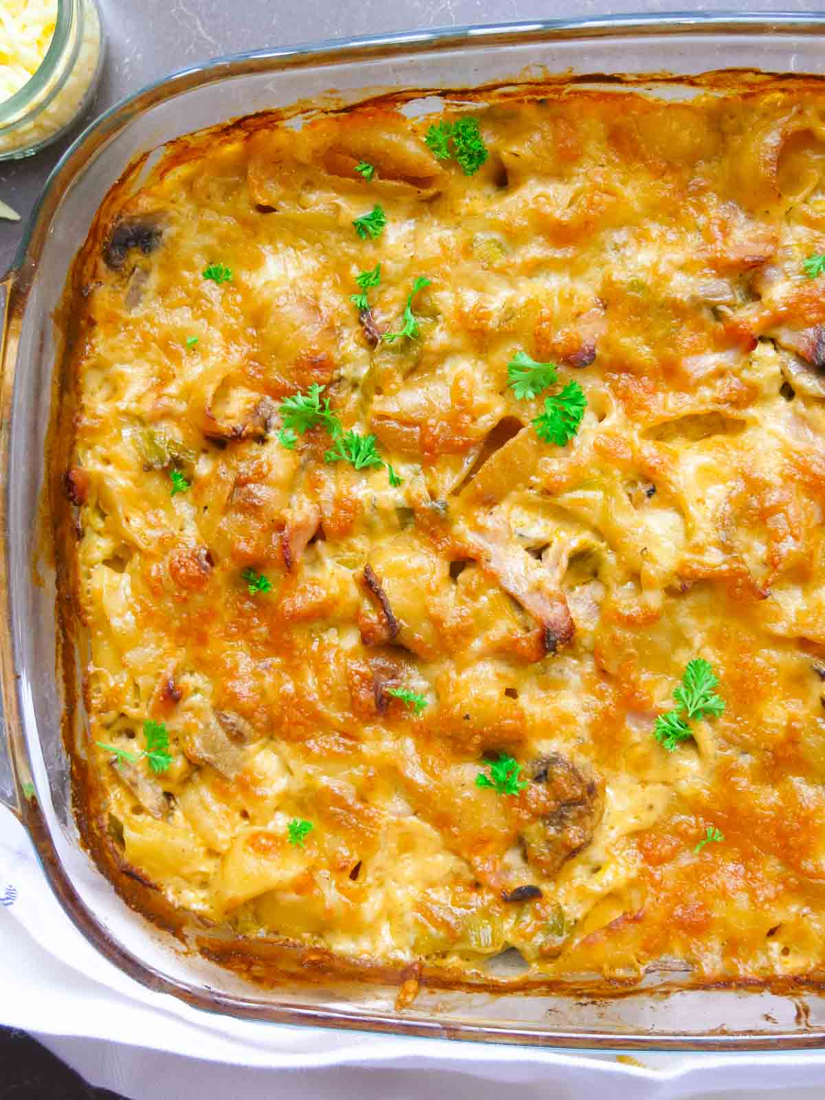 cheese, bacon and leek pasta bake in a clear Pyrex casserole dish