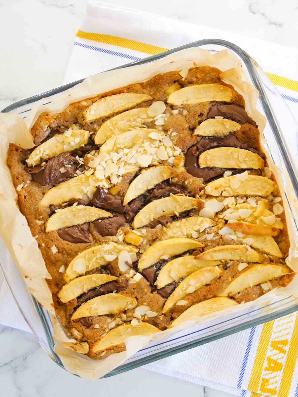 Freshly baked recipe with apple, chocolate and cinnamon in a square dish