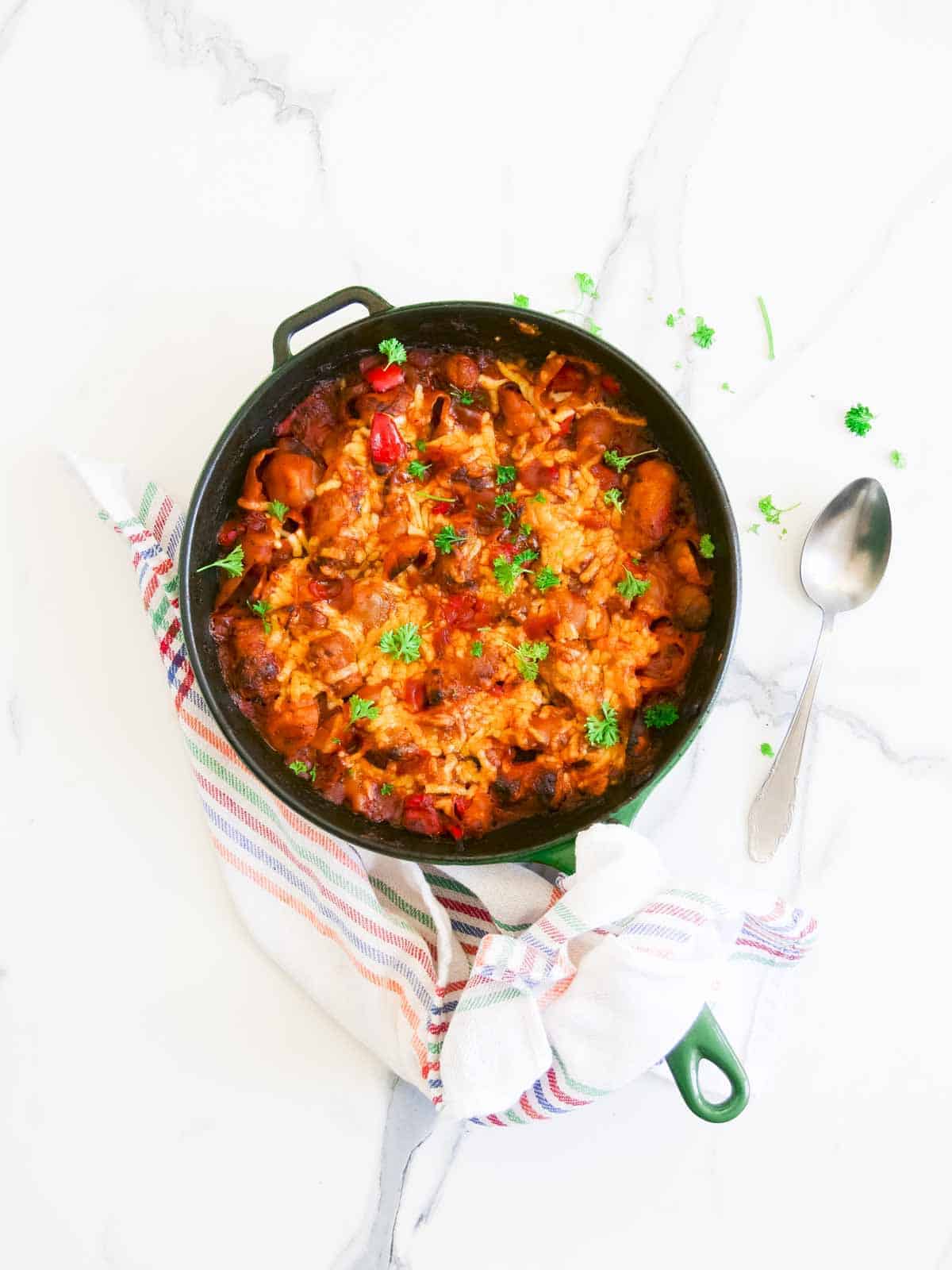cheesy and spicy tomato sauce pasta with sausage in a skillet