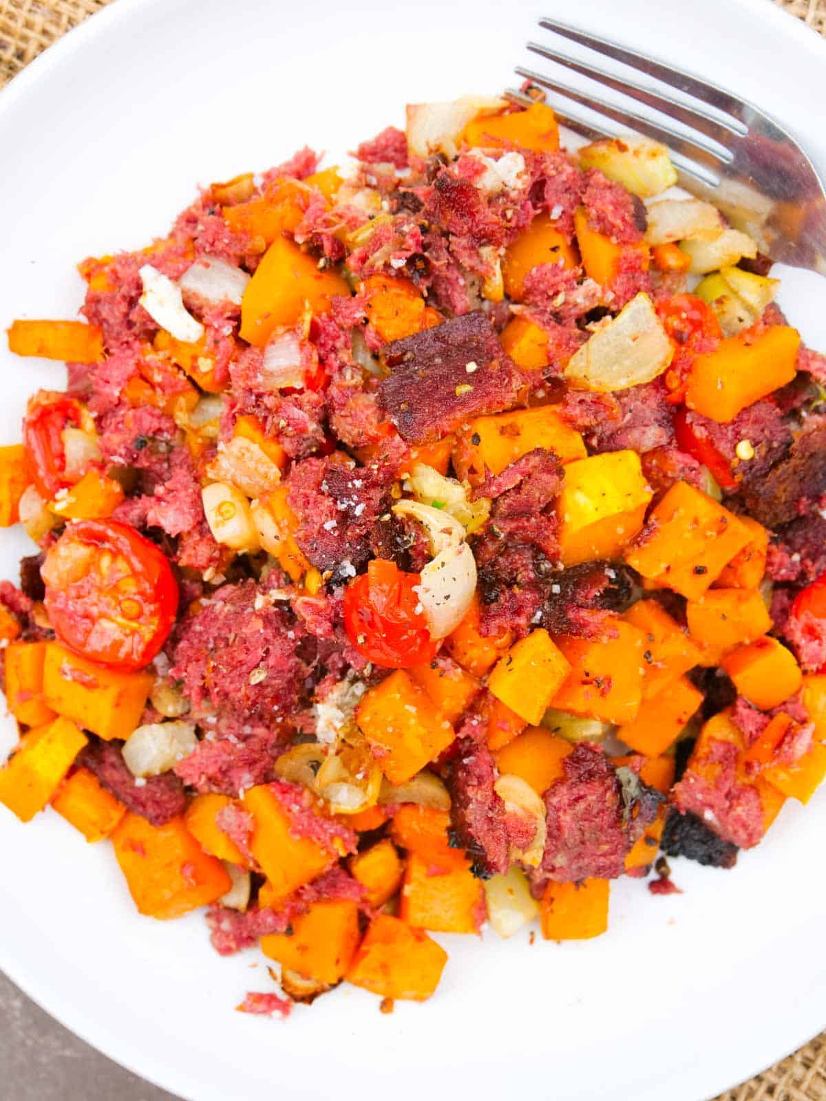 bowl of low carb corned beef with egg hidden underneath