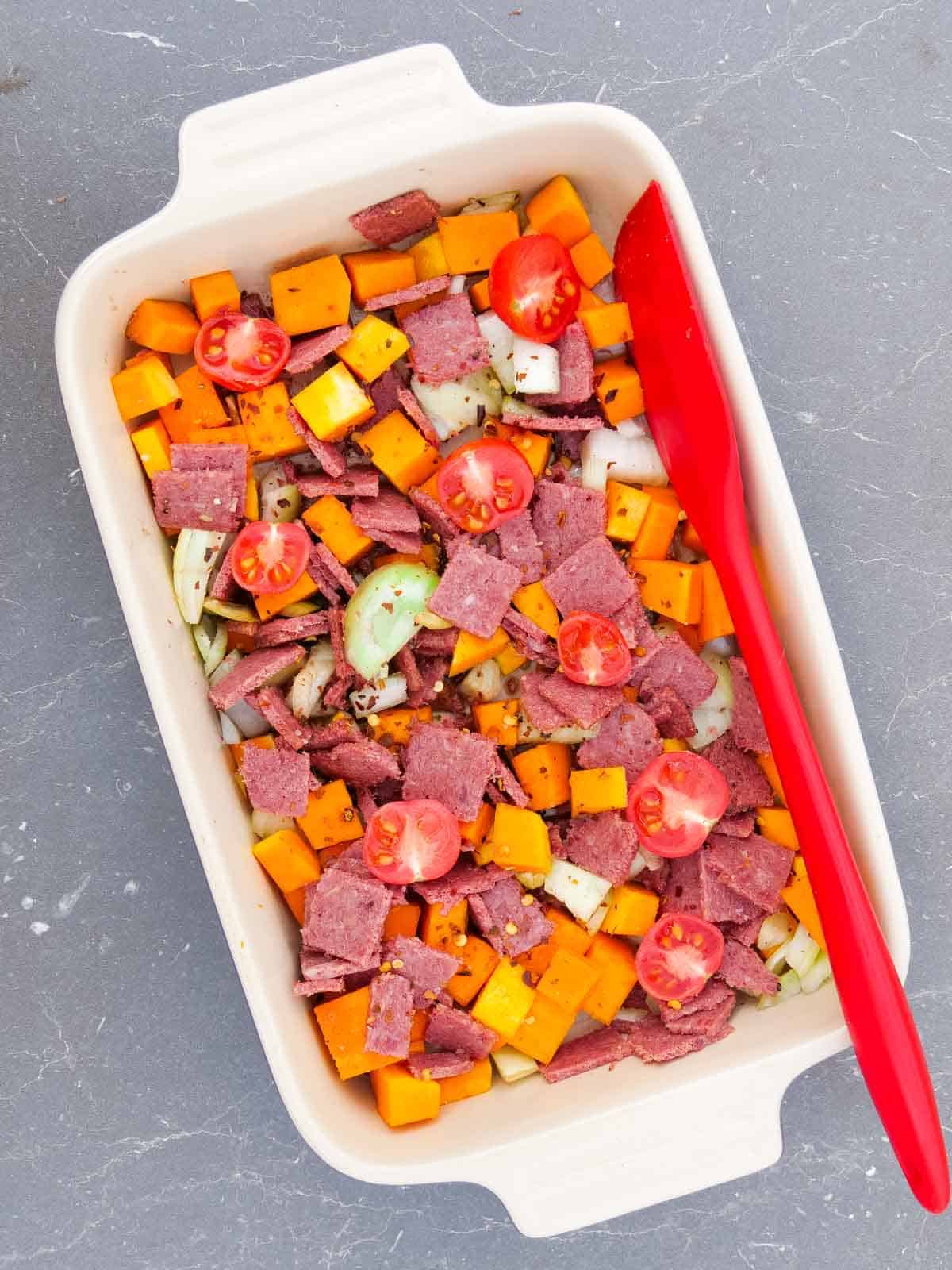 raw corned beef hash before cooking in a baking dish