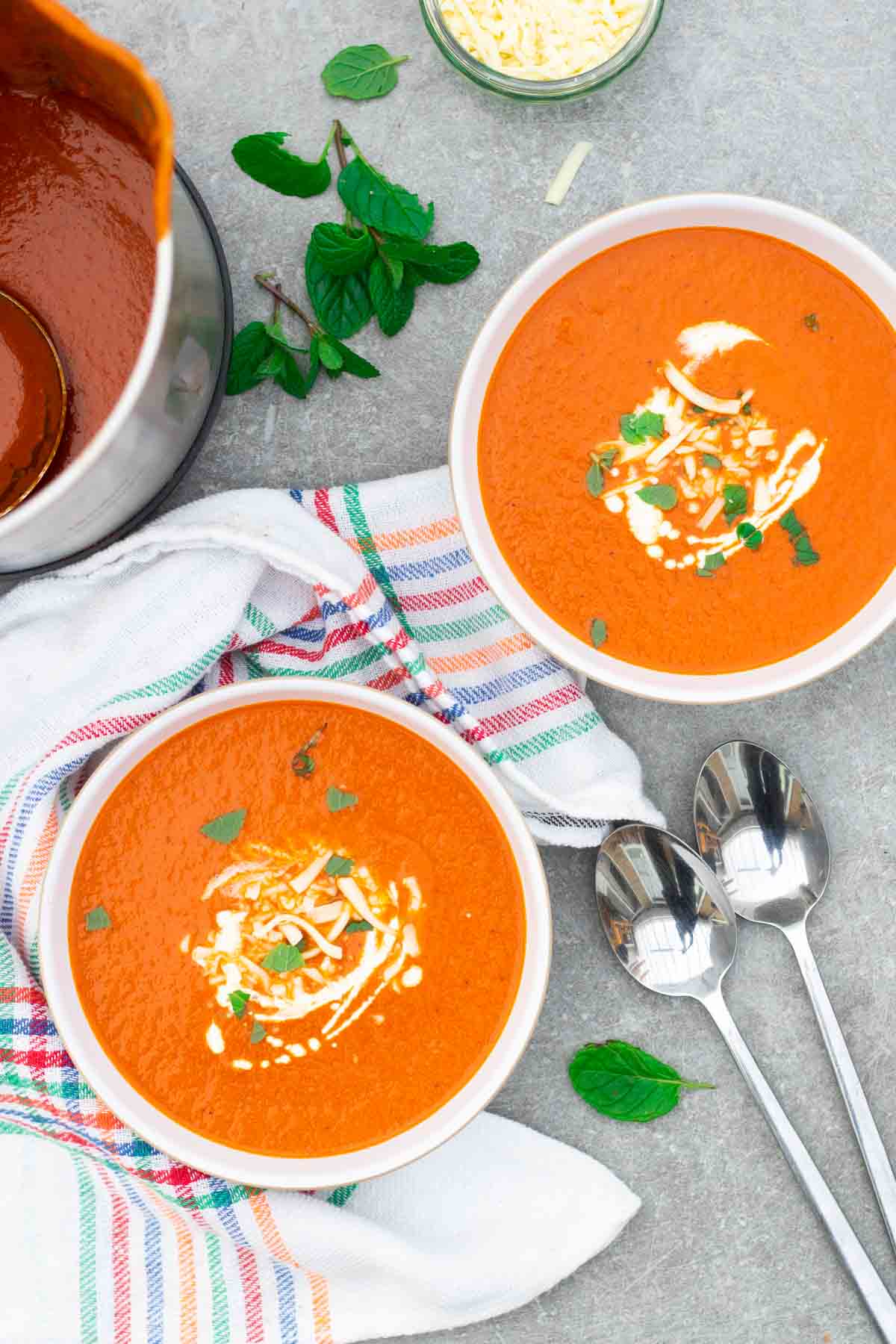 2 white Denby bowls full of red roasted pepper soup with cheese and cream on a low carb keto diet