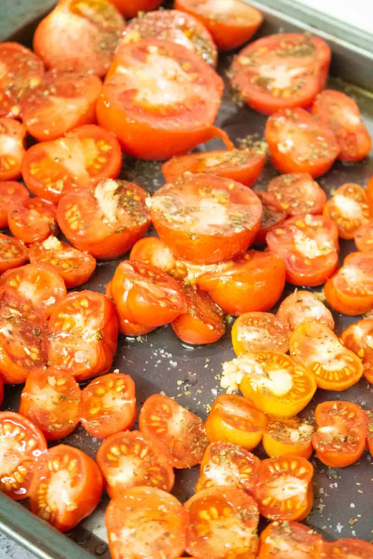 Picture on how to roast tomatoes for soup using a large metal making tray, topped with garlic, sea salt and olive oil