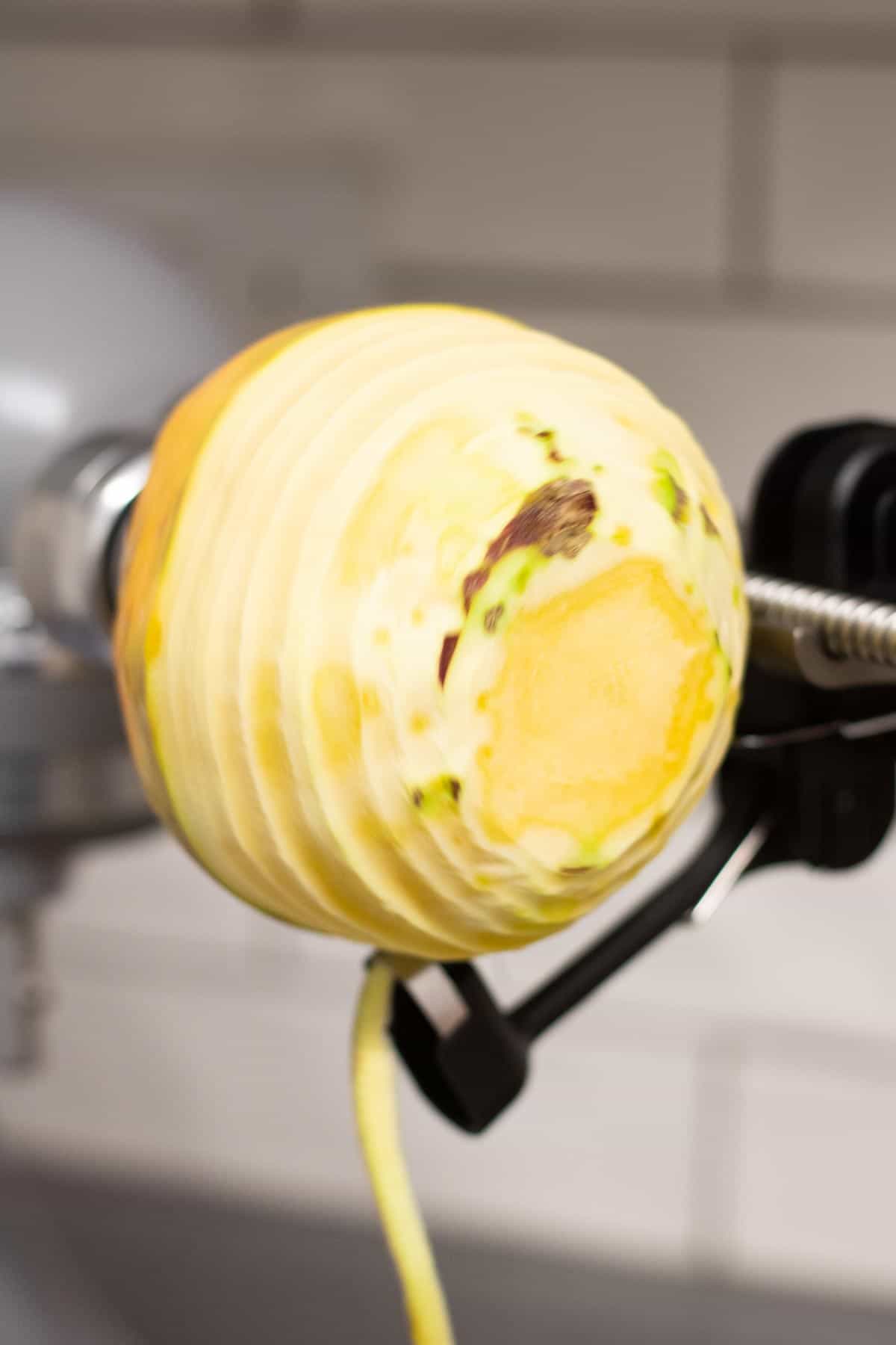 Peeling a swede using a peeler attachment on the KitchenAid 5KSM1APC Spiraliser accessory.