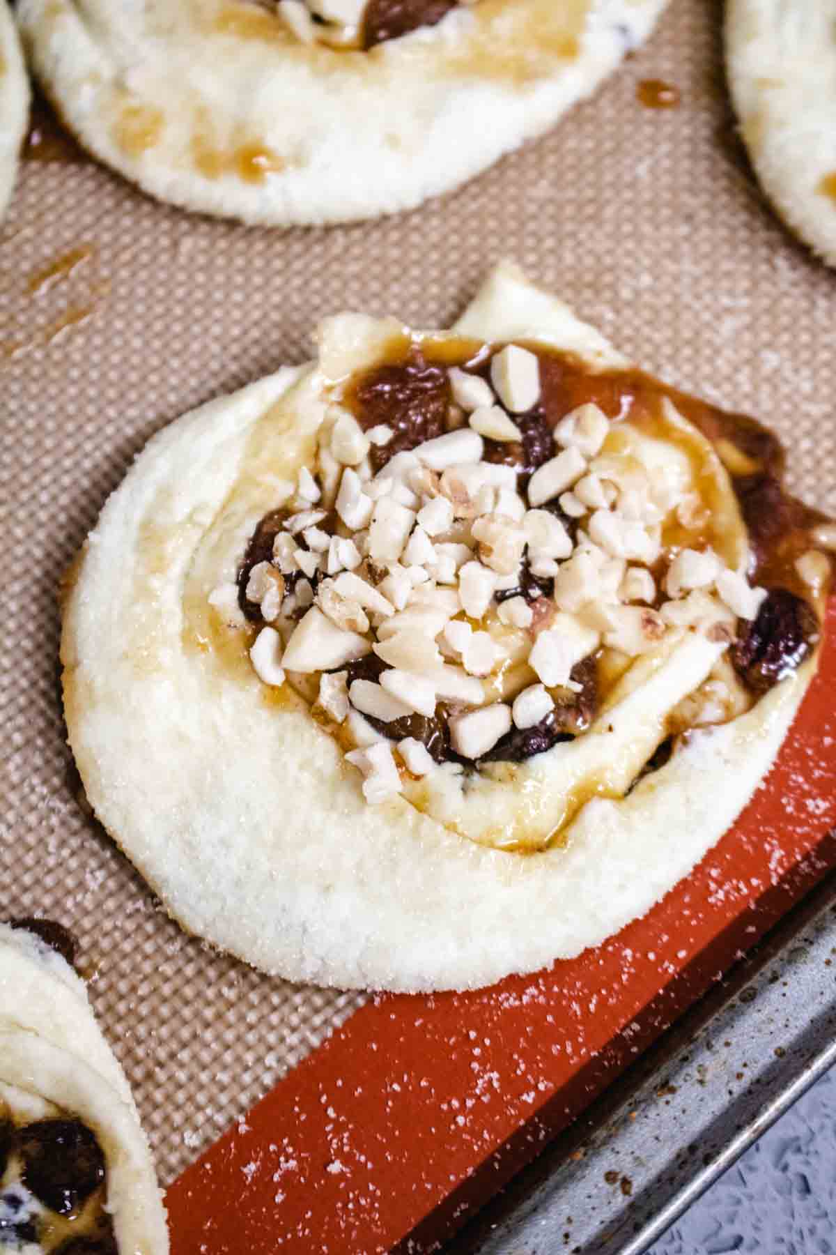 Close up of a Christmas pinwheel with chopped nut sprinkled on top