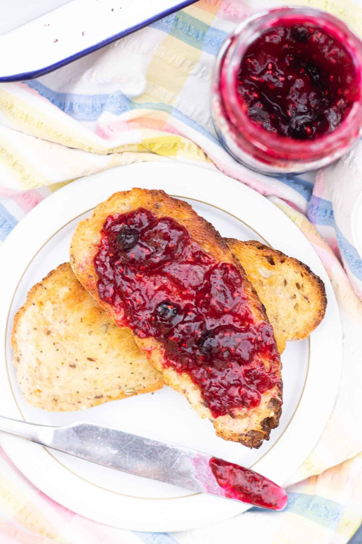 raspberry jam on toast on a table cloth