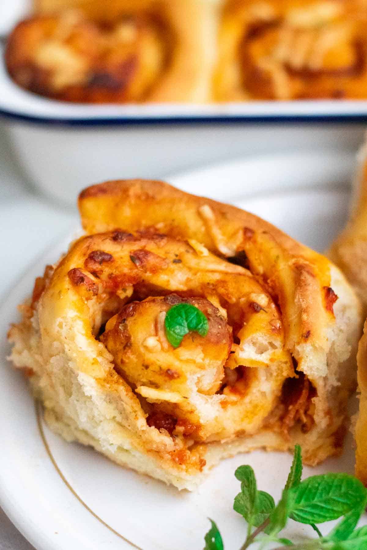 Close up of a bite mark taken out of a pepperoni cheese pizza roll