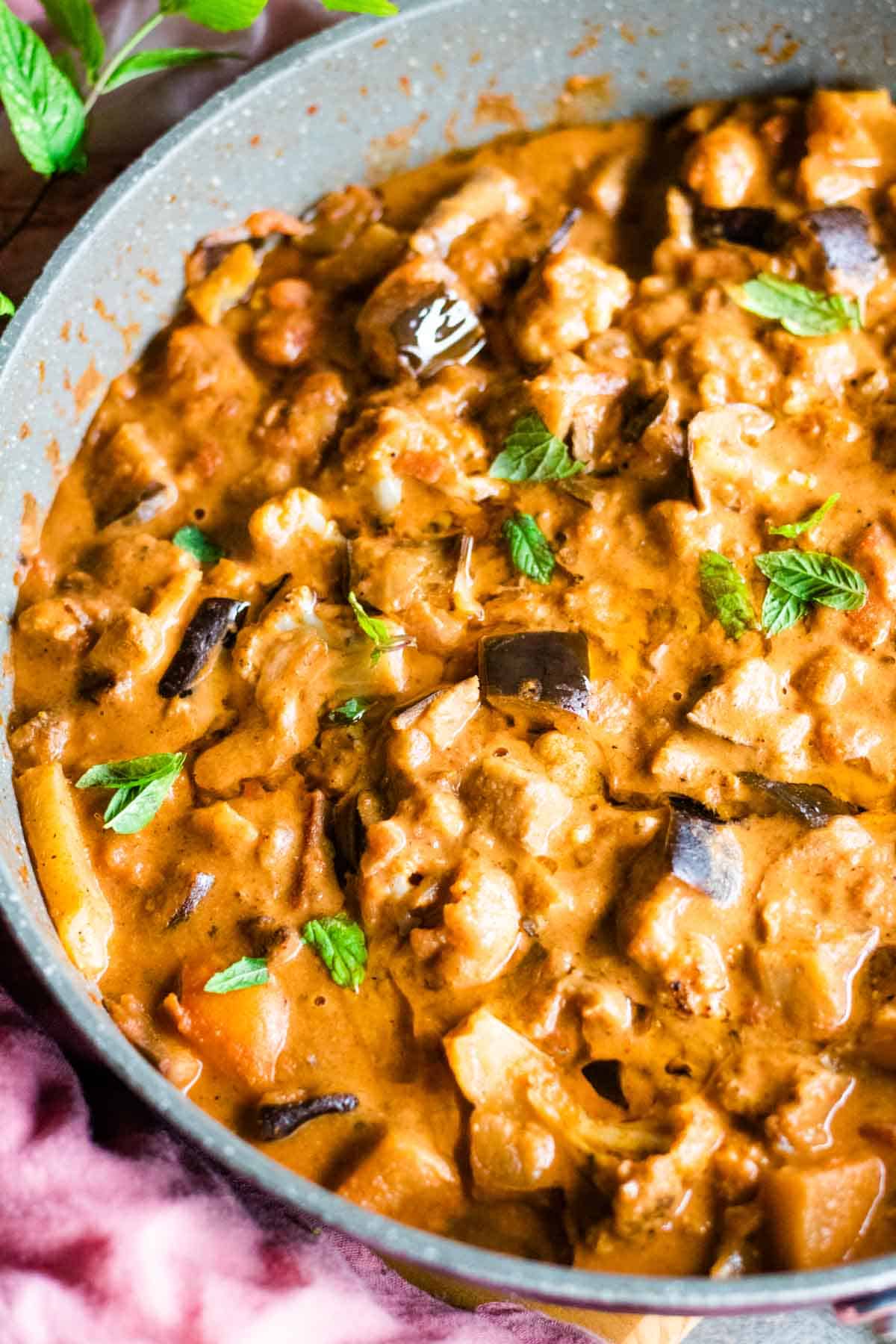 Close up of cauli curry with aubergine in a pan
