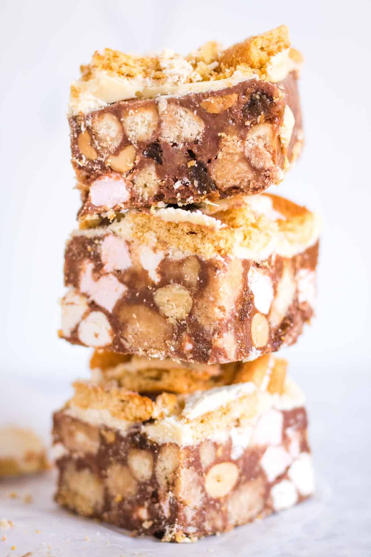 Close up of a stack of rocky roads with marshmallows, biscuits, nuts and ginger cookies