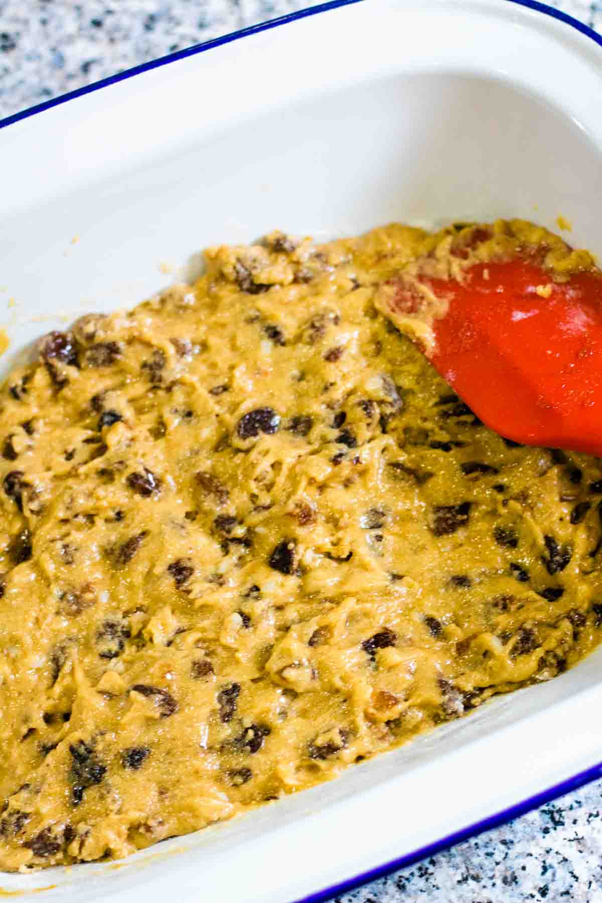 Mixed ready made mincemeat mixed with gluten free cake mix in a white enamel baking dish