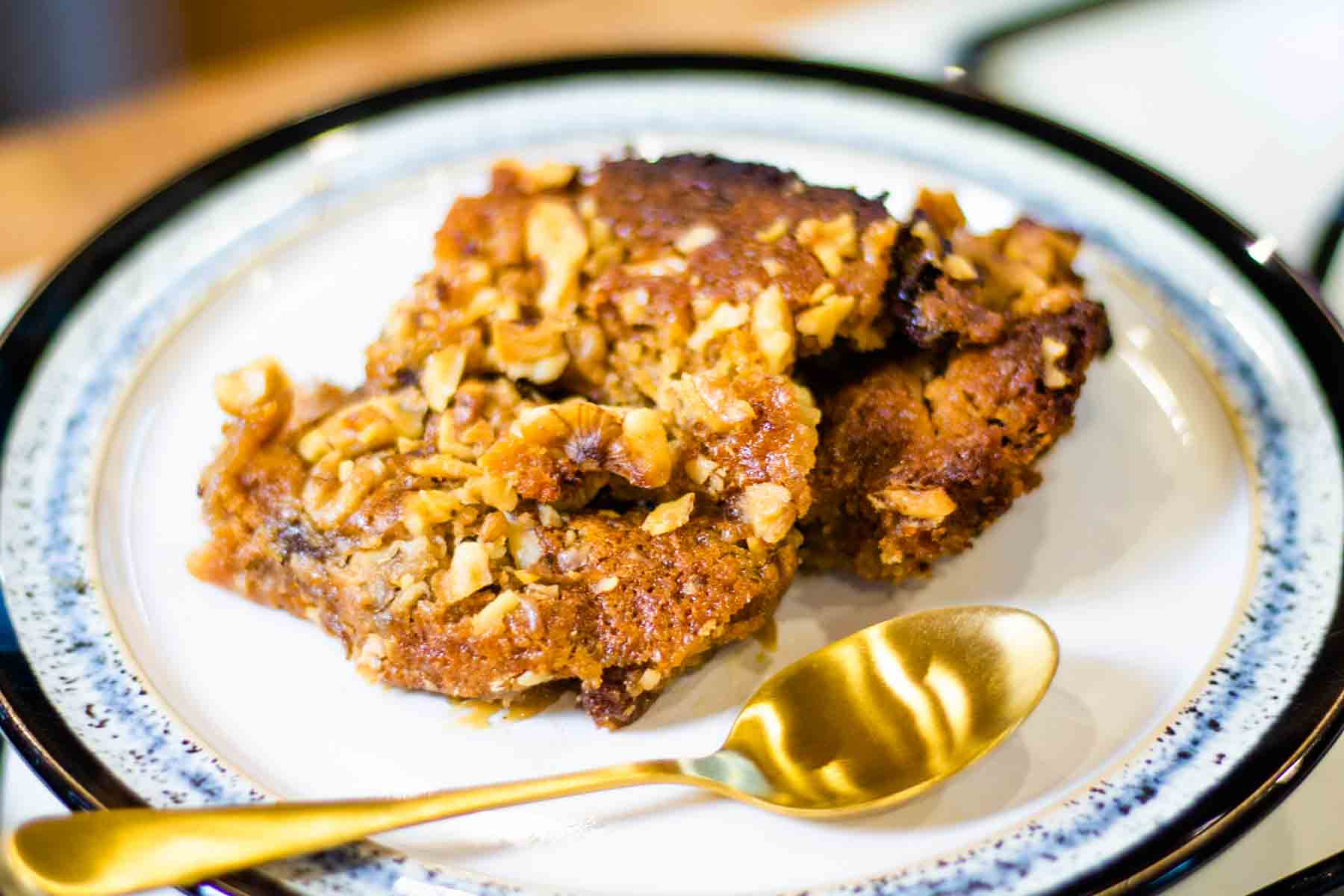A small plate of baked mincemeat dump cake with chopped walnuts and gluten free cake mix