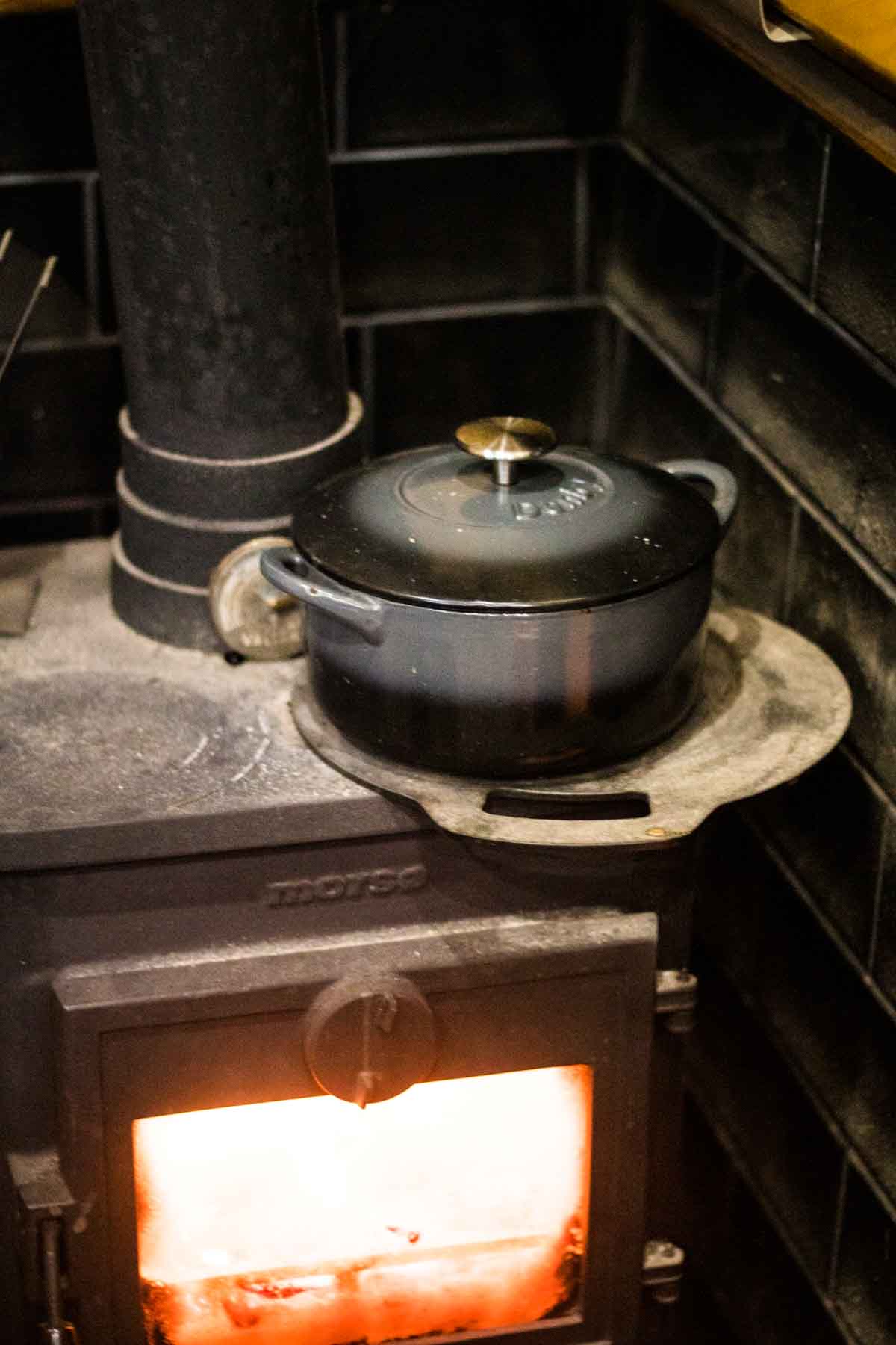 Denby cast iron dish slow cooking with red cabbage inside on a Morso multi fuel narrowboat stove