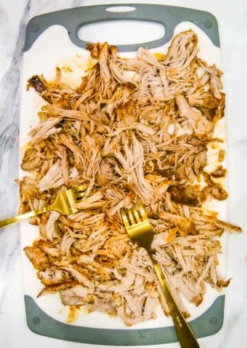 Shredded pork on a chopping board