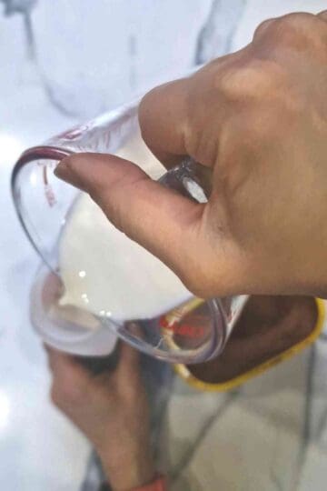 pouring in ¾ cup milk into the dry pancake mix