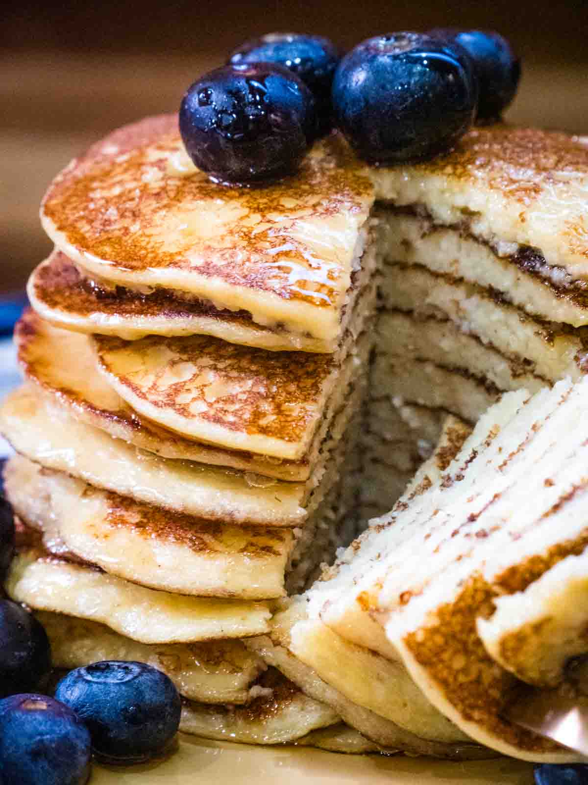 close up of a wedge cut out of stack of pancakes