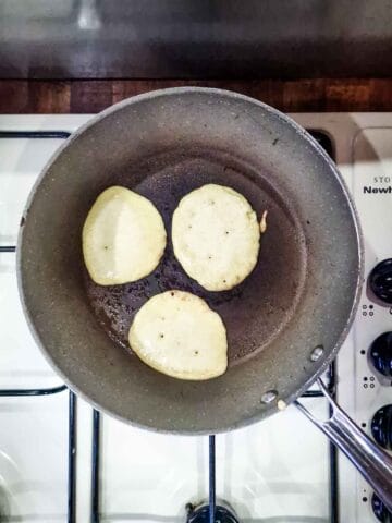 pancake batter spooned into a frying pan
