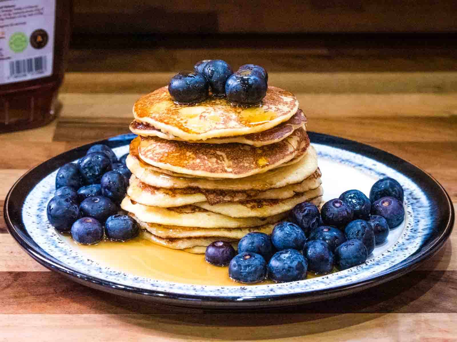stack of oat cottage cheese pancakes on a plate with syrup