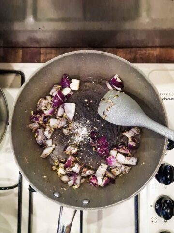 frying onions and garlic in a frying pan on the hob