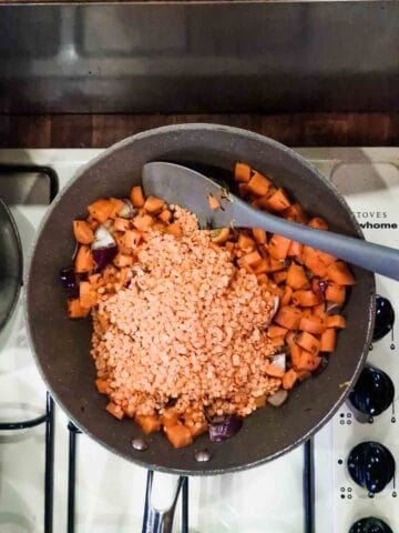 carrots and red lentils cooking in a pan