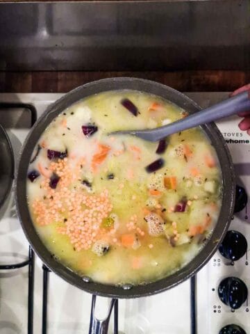 stock and milk in a pot cooking