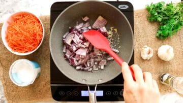 stir frying onions and garlic in a pan over the hob