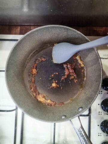 garlic, chili, ginger and siracha being pan fried in oil
