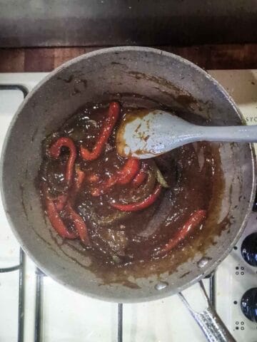 peppers,brown sugar, cornflour slurry being cooked until thick in a pan