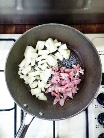 bacon and onions in a frying pan