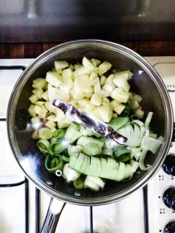 leek and potatoes cooking in a frying pan