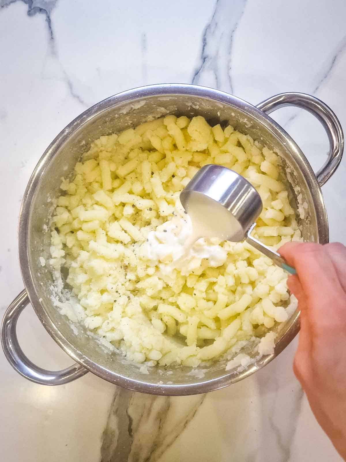 mashed potatoes with milk being poured in