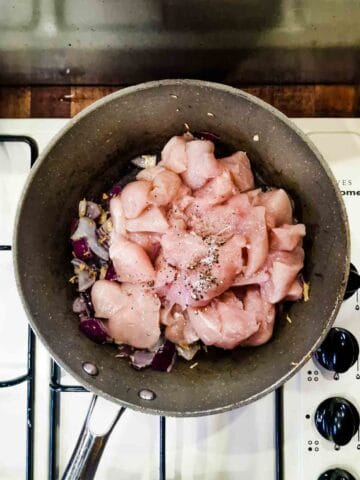 diced chicken being cooked in a pan