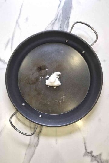 coconut oil in a paella pan with handles