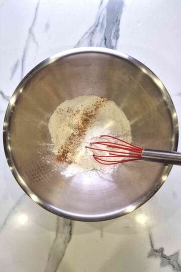 Dry ingredients being mixed in a large mixing bowl