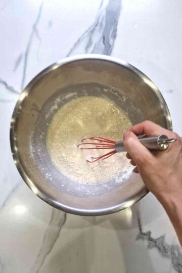 Mixing dutch pancake batter in a stainless steel mixing bowl