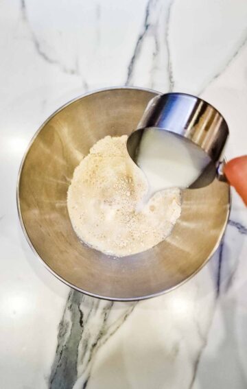 pouring in plant based milk in oat flour