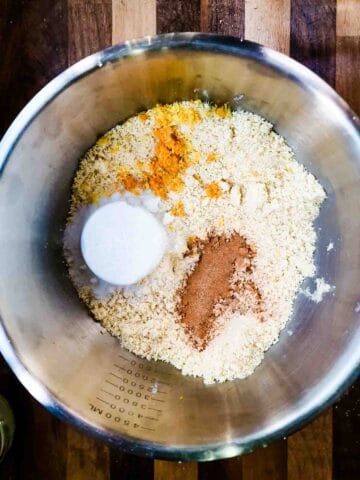 baking sugar, spices and citrus peel added to fine breadcrumbs in a large bowl