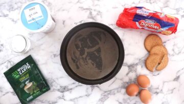 springform pan lined with a piece of baking paper ready for cheesecake