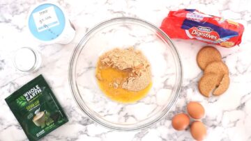 biscuit breadcrumbs and melted butter in a large glass mixing bowl before mixing well